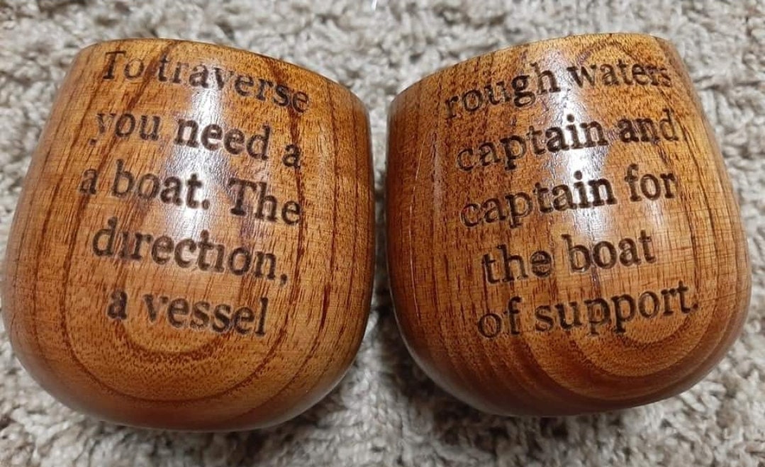 Laser engraved wooden whiskey cups.